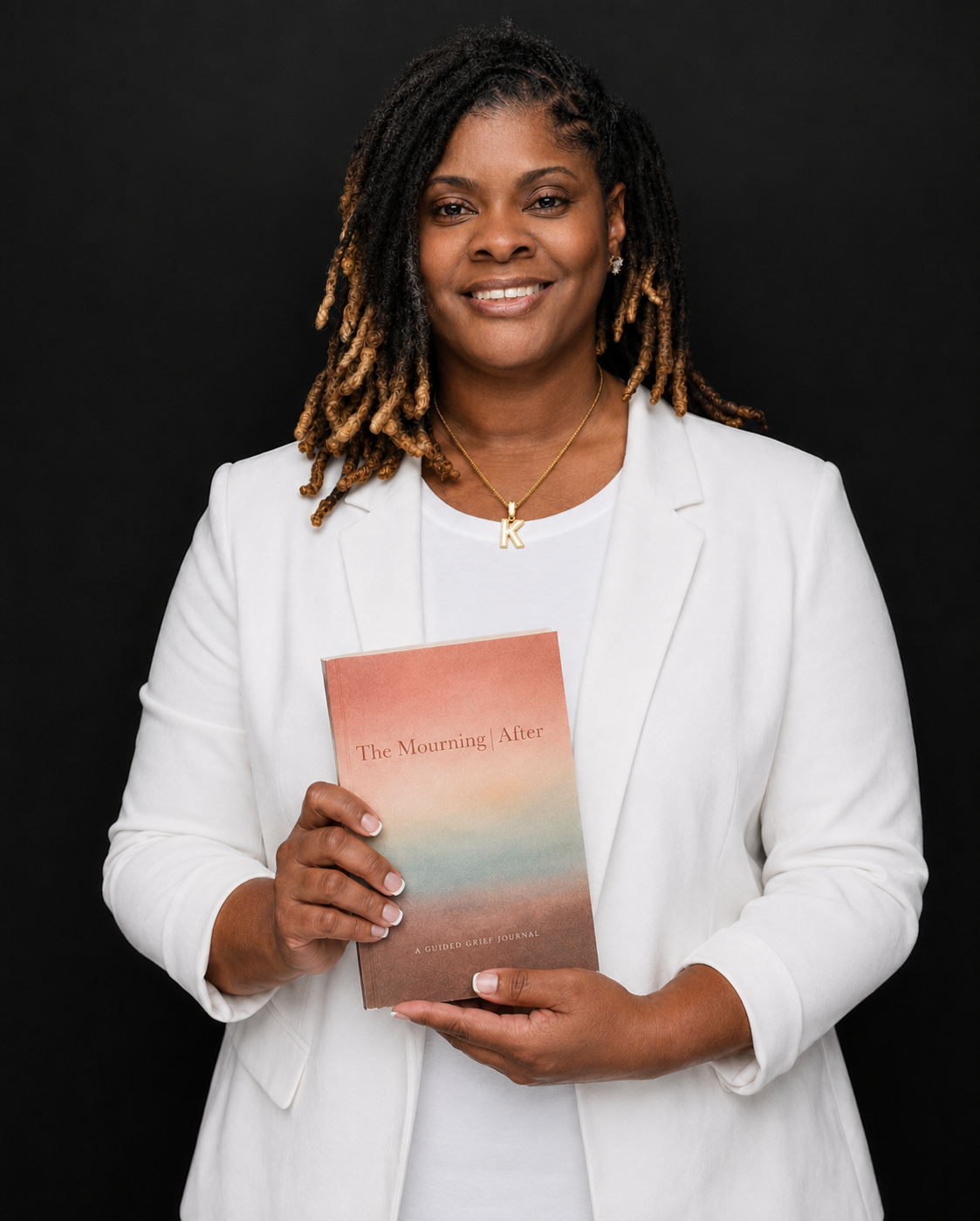Kandice McKinney holding The Mourning After: A Guided Grief Journal